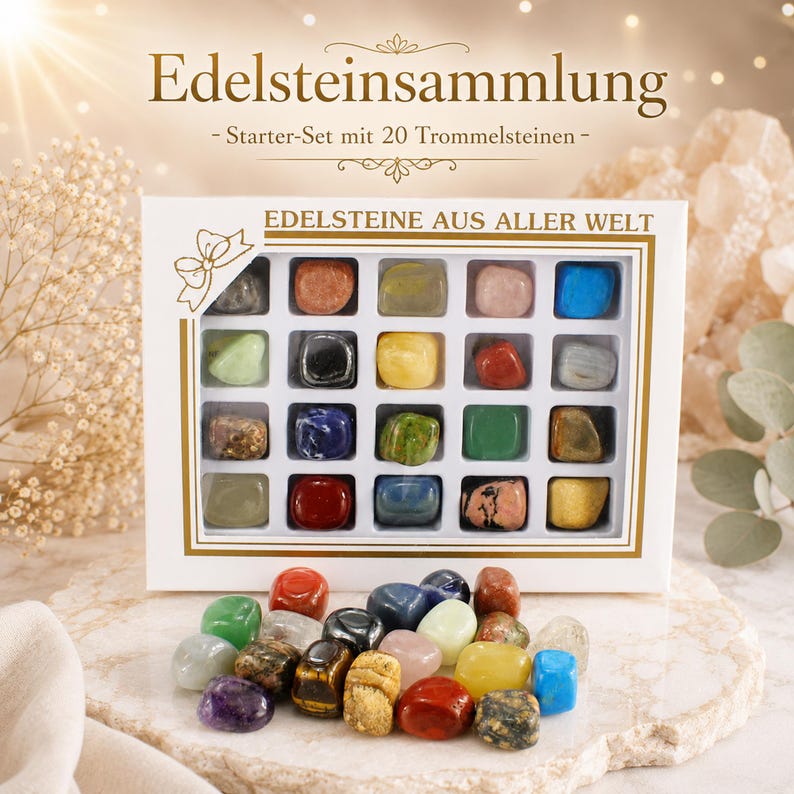 Puede incluir: Una caja blanca con 20 piedras preciosas pulidas de varios colores, incluyendo verde, rojo, azul y amarillo. La caja tiene bordes dorados y texto en alem&aacute;n. Un mont&oacute;n de piedras preciosas sueltas se encuentra frente a la caja. La caja est&aacute; etiquetada "Edelsteinsammlung".