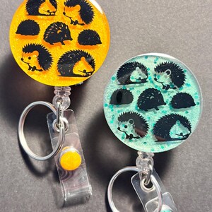 Hedgehog lover badge reel: multilple colors to choose from. Simple, lightweight, black hedgehog with colorful background, gift idea