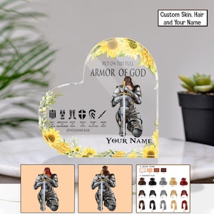 May include: A heart-shaped acrylic plaque with a kneeling knight and sword, framed by sunflowers. The text reads "PUT ON THE FULL ARMOR OF GOD" and "YOUR NAME". Additional text includes "EPHESIANS 6:10" and options for customisation.