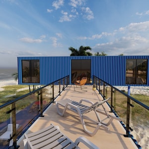 Render of a pre-engineered shipping container home (C1), showcasing a sustainable, modern, and minimalist design, perfect for a tiny modular metal home. A blue container home with a wooden deck and black railing. The deck has two white lounge chairs and a brown chair. The home is on a sandy beach with green grass and palm trees. The ocean is in the background with a sailboat in the distance. The text 'Oasis Engineering' is visible in the upper right corner of the image.