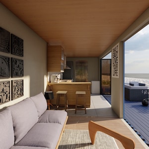 Render of a pre-engineered shipping container home (C1), showcasing a sustainable, modern, and minimalist design, perfect for a tiny modular metal home. A living room interior with a gray couch, a wooden coffee table, and a kitchen with a wooden countertop and bar stools. The room has a large window that opens to a view of a beach with blue water and a sandy shore. The window has a sign that reads 'Take it easy, live your life'.