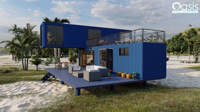 Render of a pre-engineered shipping container home (C1), showcasing a sustainable, modern, and minimalist design, perfect for a tiny modular metal home. A blue container home with a wooden deck and a balcony. The home is situated on a sandy beach with green grass and palm trees in the background. The home has large windows and a glass railing on the balcony. The text 'Oasis Engineering' is visible in the top right corner of the image.