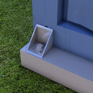 May include: A close-up of a metal bracket attached to a blue surface. The bracket has a silver finish and a single bolt in the center.