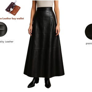 May include: A long, black leather skirt with a high waist and a flared silhouette. The skirt is made of premium quality leather and features detailed stitching. The image also includes a leather key wallet.