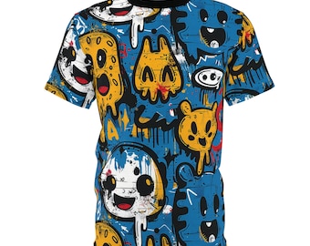 May include: A blue t-shirt with a colorful, cartoon-style print of various characters and designs. The print includes yellow, red, white, and black elements.
