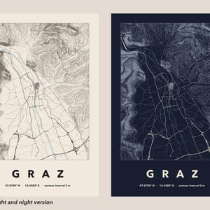 May include: Two topographic map prints of Graz, Austria, displayed side-by-side. One print features a light beige background with dark lines, while the other has a dark navy background with light lines. Both include the text GRAZ, 47.0709 N - 15.4383 E, and contour interval 5 m.