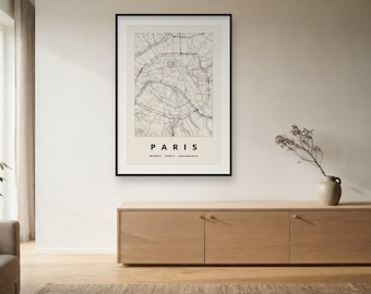 May include: A framed wall art print featuring a detailed black and white map of Paris, France. The print includes the text PARIS in bold capital letters, along with geographic coordinates and the phrase 'capitale française' at the bottom.