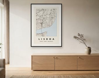 May include: A framed wall art print featuring a topographic map of Lisbon, Portugal. The map displays black road lines over a beige background with a light blue water section. The text LISBOA is printed in black below the map with coordinates.