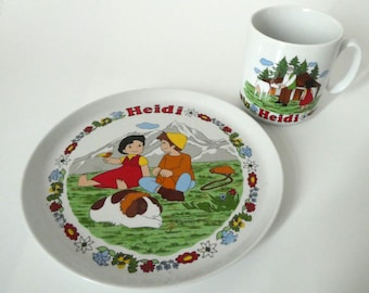 Kindergeschirr von Rösler mit Motiven aus dem Zeichentrickfilm Heidi von 1986, Becher mit Heidi und Großvater, Teller mit Heidi und Peter