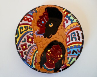 Small decorative plate by R.C. Laterza probably from the 50s with Indian faces and colorful geometric relief-like glaze