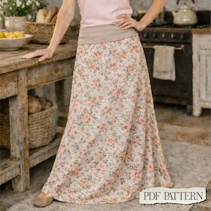 May include: A floor-length skirt featuring a light beige base with a repeating floral pattern of small pink roses and green leaves. The skirt has a wide, solid beige waistband and a straight, flowing silhouette that reaches down to the floor.