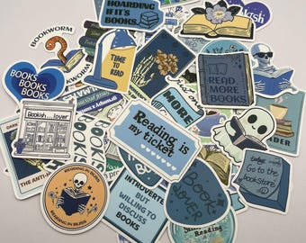 May include: A collection of blue and yellow book-themed stickers with various designs and text, including "Reading is my ticket", "Book Lover", "Read More Books", and "It's not hoarding if it's books".