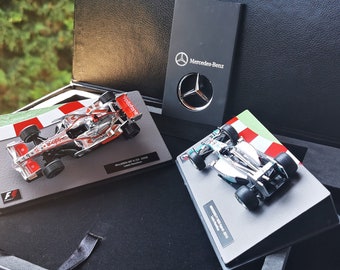 Original special Mercedes AMG silver keychain and special collection model cars driven by world champion Lewis Hamilton...