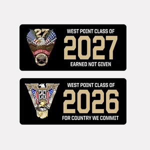 May include: Two black and gold license plate-style stickers with the text "West Point Class of" and the year "2027" or "2026". The top sticker has an eagle with American flags and the text "Earned Not Given". The bottom sticker has a military insignia with the text "For Country We Commit".