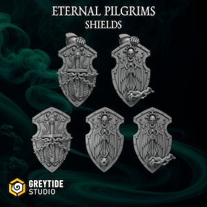 May include: Five 3D printed shields with different designs. Each shield features a skull, wings, a sword, and chains. The shields are gray and have a textured surface. The text "Eternal Pilgrims Shields" is at the top of the image.