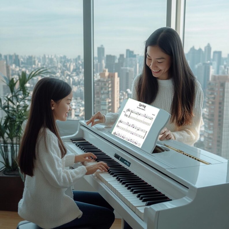 May include: A white digital piano with black and white keys. The piano has a music stand with sheet music that reads "Spring". Two people are playing the piano in front of a large window overlooking a city.