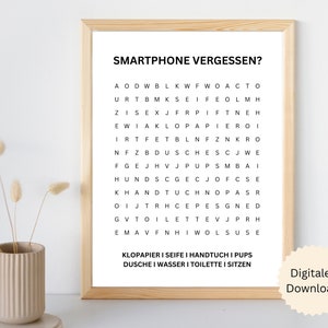 Puede incluir: Un cartel enmarcado con el texto "SMARTPHONE VERGESSEN?" encima de un juego de búsqueda de palabras. El rompecabezas contiene palabras como "KLOPAPIER" y "SEIFE". La impresión está en un marco de madera clara y es una descarga digital.