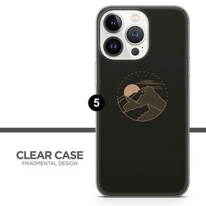 May include: A clear phone case with a black background and a gold outline of a mountain range with a sun and clouds in a circle. The text "CLEAR CASE FRAGMENTAL DESIGN" is at the bottom of the image.