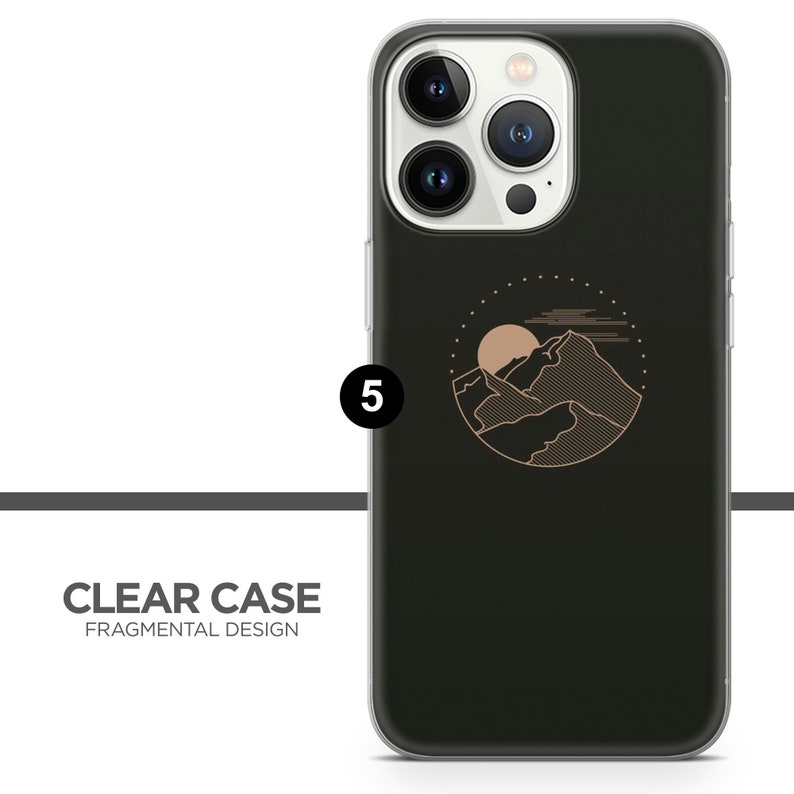 May include: A clear phone case with a black background and a gold outline of a mountain range with a sun and clouds in a circle. The text "CLEAR CASE FRAGMENTAL DESIGN" is at the bottom of the image.