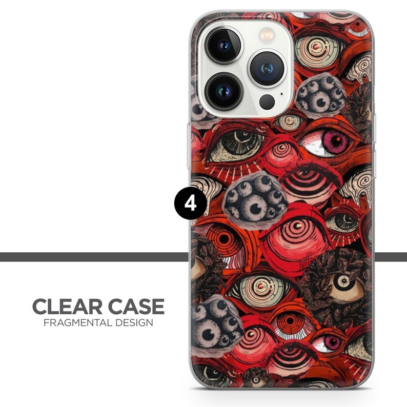K&ouml;nnte beinhalten: Eine transparente Handyh&uuml;lle mit einem roten, schwarzen und wei&szlig;en Augen-Design. Die H&uuml;lle ist kompatibel mit dem iPhone 14 Pro.
