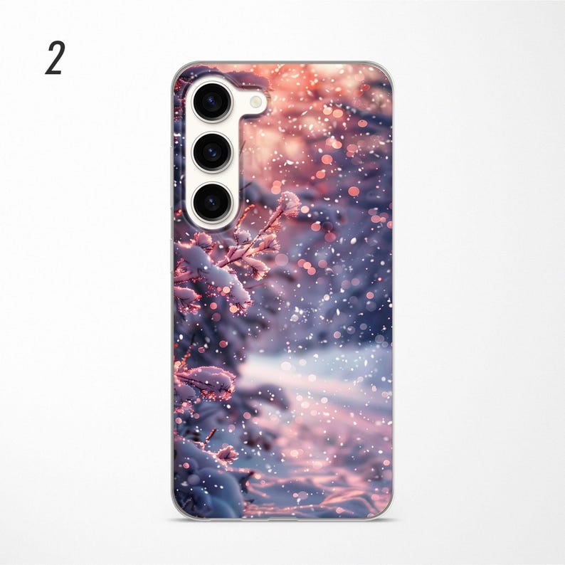 May include: A phone case with a winter scene featuring a snowy forest with a pink and white color scheme. The case has a camera cutout with three lenses.