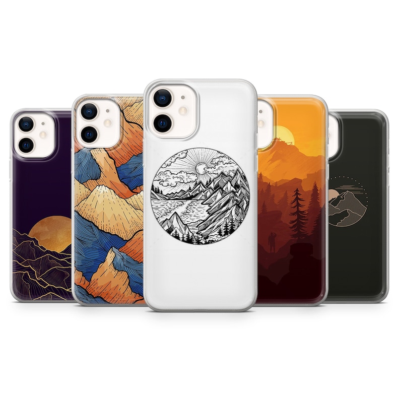 May include: Five different iPhone cases with mountain and nature-inspired designs. The cases are all clear and show the phone's camera lens. The designs include a mountain range with a sun and clouds, a mountain range with a river, a sunset over a mountain range, a mountain range with a moon, and a mountain range with a star.