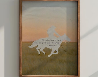 May include: Framed artwork featuring a silhouette of a rider on a horse, set against a sunset backdrop. The artwork includes the text "When the time is right, I the Lord will make it happen." in a decorative font. The frame is made of wood.
