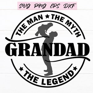 May include: Black and white graphic design with a silhouette of a person holding a child. The text reads "The Man The Myth Grandad The Legend" with a star on either side of the text.