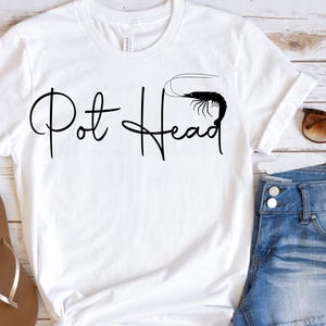 May include: White t-shirt with black text that says "Pot Head" and a shrimp graphic.