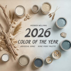 May include: An overhead shot of paint cans in various neutral colors, arranged around the text "2026 COLOR OF THE YEAR" by Sherwin Williams. The palette includes shades of white, beige, and blue-gray. Natural elements like driftwood and dried grasses are also present.
