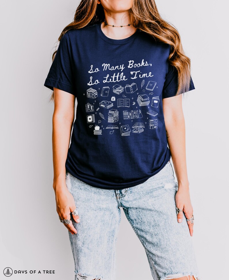 May include: A navy blue t-shirt with a white graphic of books and the text "So Many Books, So Little Time".