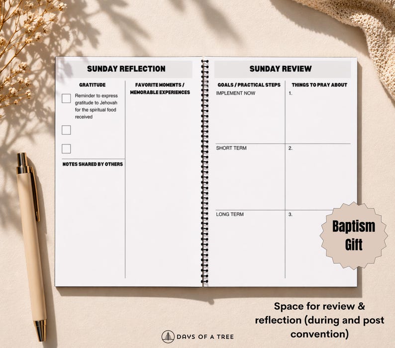 May include: Open spiral-bound notebook with sections for Sunday reflection and review. The notebook includes prompts for gratitude, goals, and prayer. A beige pen rests on the left. The text "Baptism Gift" is visible.