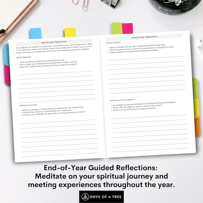 May include: Open journal with colorful tabs, titled "End-of-Year Reflections." The journal prompts reflection on spiritual milestones, challenges, and contributions. The text encourages meditation on the year's journey and meeting experiences. The journal is open on a white surface.