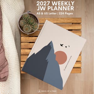 May include: A 2027 weekly JW planner with 224 pages in A5 and US Letter sizes. The cover features a graphic illustration of a dark blue mountain range, a large terracotta sun, and small black birds against a light beige background.
