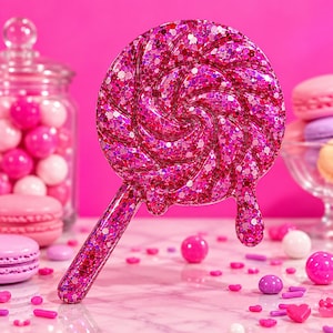 May include: A circular lollipop-shaped hairbrush featuring a vibrant pink glitter finish with a swirling pattern and a dripping effect on the side. The handle is straight and matches the glittery pink design of the brush head.