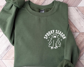 May include: A green sweatshirt with a white ghost and the text "Spooky Season" printed on the front.