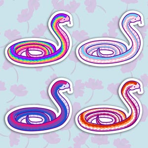 May include: Four colorful snake stickers with white outlines. The snakes are curled up in a circle and have a rainbow, transgender, bisexual, and lesbian pride flag color scheme.