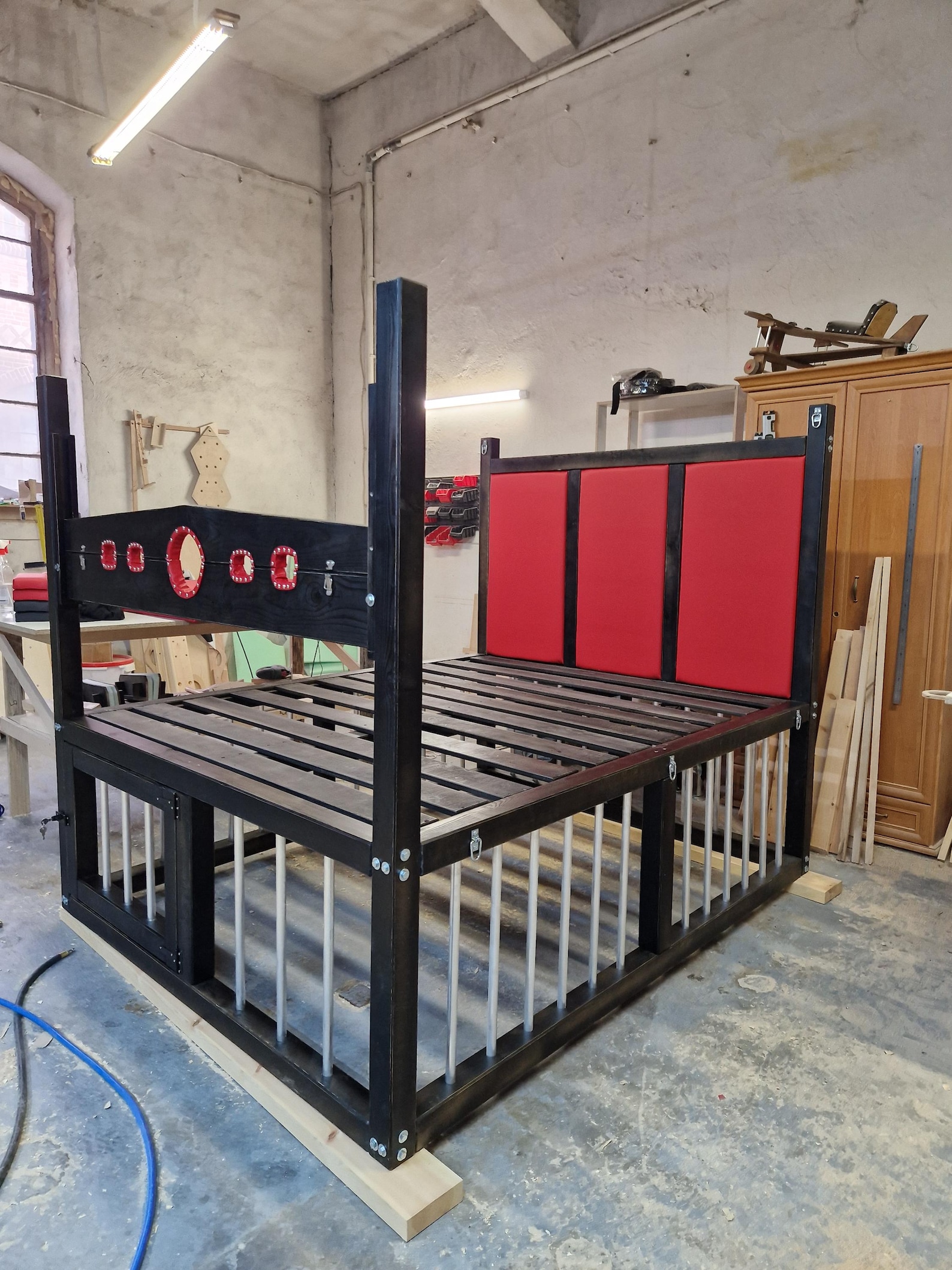 King size bdsm bed with cage, shackles, and padded headboard, ideal sex dungeon furniture for bondage and restraint play.