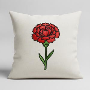 May include: A square off-white throw pillow featuring a centered machine-embroidered design of a single red carnation flower with a green stem and two leaves. The embroidery uses bold black outlines to define the petals and foliage on the fabric.