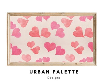 May include: A framed print with a pink and white watercolor pattern of hearts. The print has the text "URBAN PALETTE Designs" at the bottom.