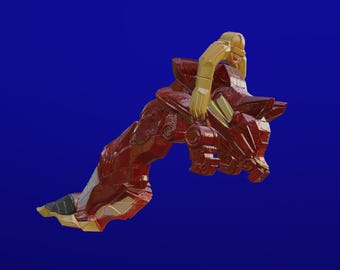 Puede incluir: Una escultura roja y dorada de una criatura mítica con un jinete, sobre un fondo azul. La escultura tiene detalles intrincados y un brillo metálico, lo que sugiere un tema de fantasía.