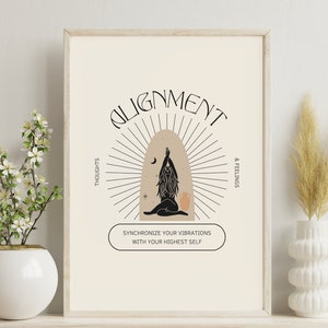 May include: A framed art print with the word "ALIGNMENT" at the top. The artwork features a stylized illustration of a person in a yoga pose, with radiating lines and the text "SYNCHRONIZE YOUR VIBRATIONS WITH YOUR HIGHEST SELF". The print is in a neutral color palette.
