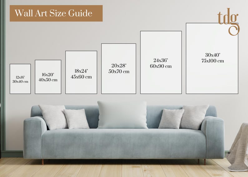 May include: Wall art size guide with six different sizes of white frames on a white wall. The sizes are 12x16 (30x40 cm), 16x20 (40x50 cm), 18x24 (45x60 cm), 20x28 (50x70 cm), 24x36 (60x90 cm), and 30x40 (75x100 cm). A light blue sofa is in the foreground.