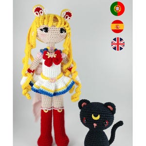 May include: A handmade crochet doll of a character with long yellow hair, a white and blue dress, and red boots. A black cat with a yellow crescent moon is also crocheted. The doll is approximately 30 cm tall.