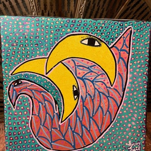 May include: Abstract painting on canvas with a yellow crescent moon shape with a black eye and a pink and blue shape with a black eye. The background is a teal green with purple and pink dots. The painting is signed "Leroy Sul 2.17".
