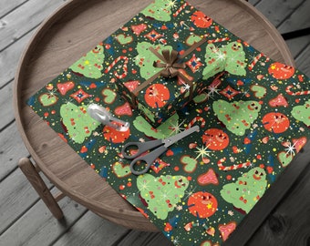 May include: Green wrapping paper with a repeating pattern of gingerbread cookies, candy canes, and Christmas trees. A small gift box is wrapped in the paper and tied with a brown ribbon.