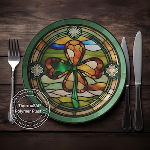 May include: A green and gold shamrock design on a round dinner plate with a green rim. The plate is made of ThermoSaf Polymer Plastic and is microwave and dishwasher safe.