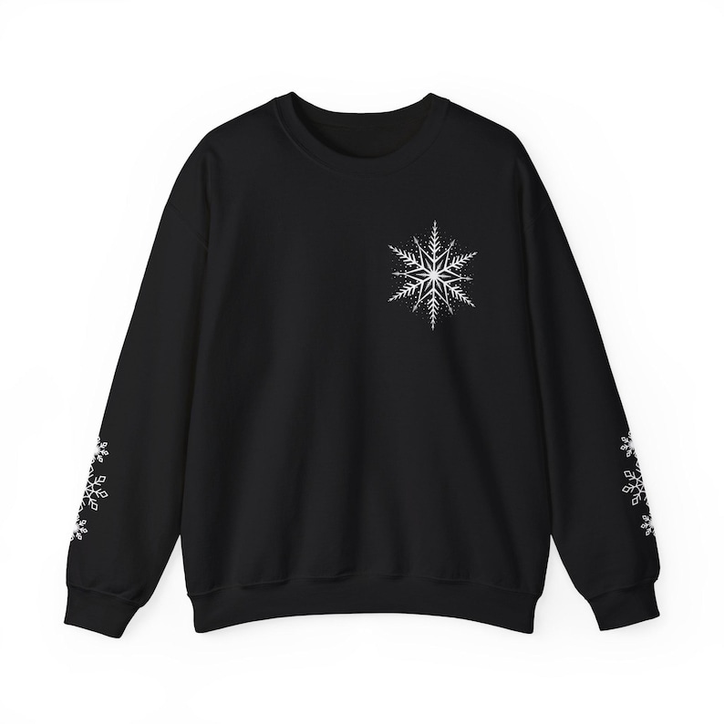 May include: Black sweatshirt with a white snowflake design on the front and white snowflakes on the sleeves.