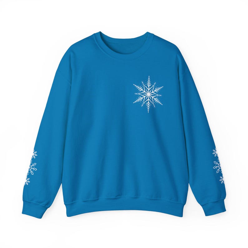 May include: A bright blue sweatshirt with white snowflake designs on the sleeves and a larger snowflake design on the front.