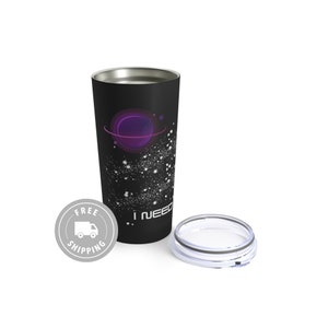 May include: Black travel tumbler with a silver rim and lid. The tumbler features a purple planet design with white star-like specks and the text "I NEED". The lid is off to the side.